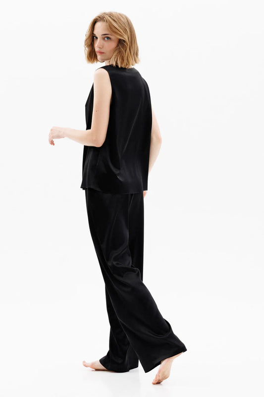 Woman wearing a black silk sleeveless top (sold separately) and black silk pants showing the back