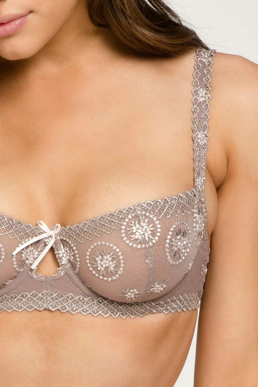 The Chantilly Medallions Balcony Bra from the Louisa Bracq line features a geometric border that accents the lustrous medallions on the cups.