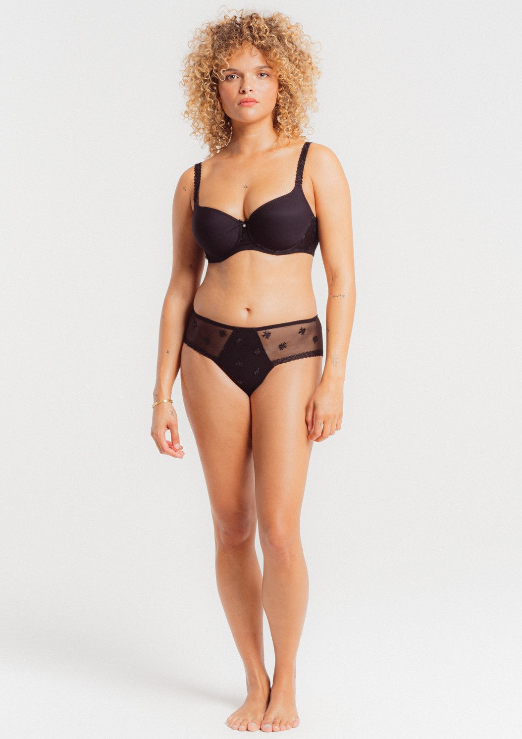 The Louisa Bracq shorty from the Chantilly line has a polished, sophisticated look featuring geometric leg-lines which showcase the surrounding iridescent medallions.