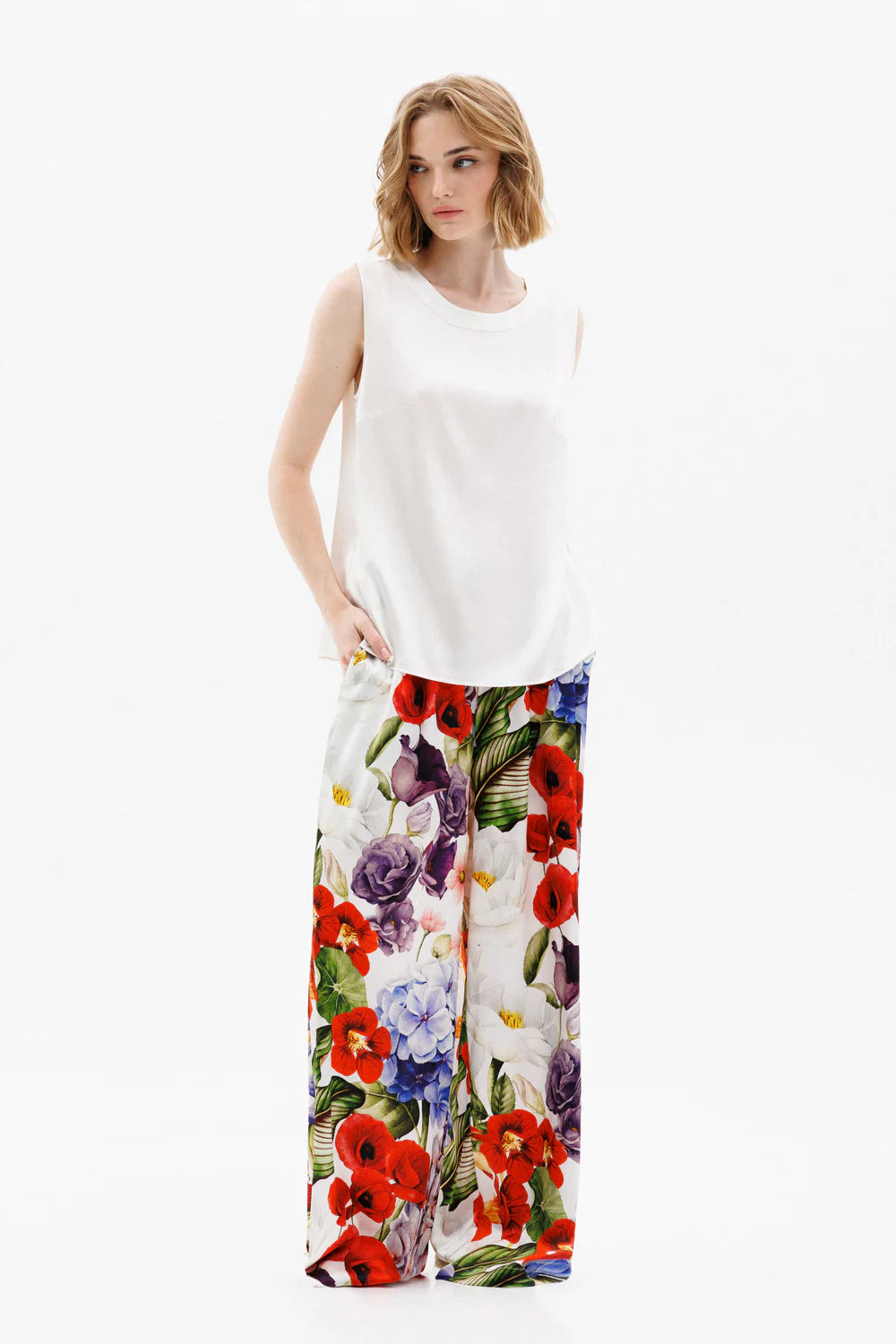 Woman wearing a white silk sleeveless top and colorful silk pants (sold separately) showing the front full look