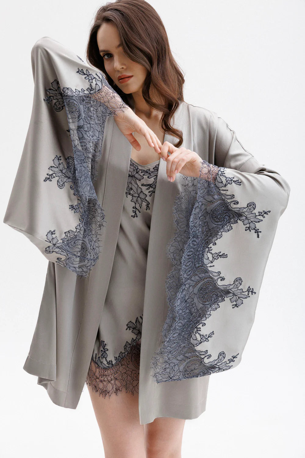 Woman wearing a gray silk robe with Leavers Lace sleeves showing the elegance of the sleaves and beauty of the anthracite lace