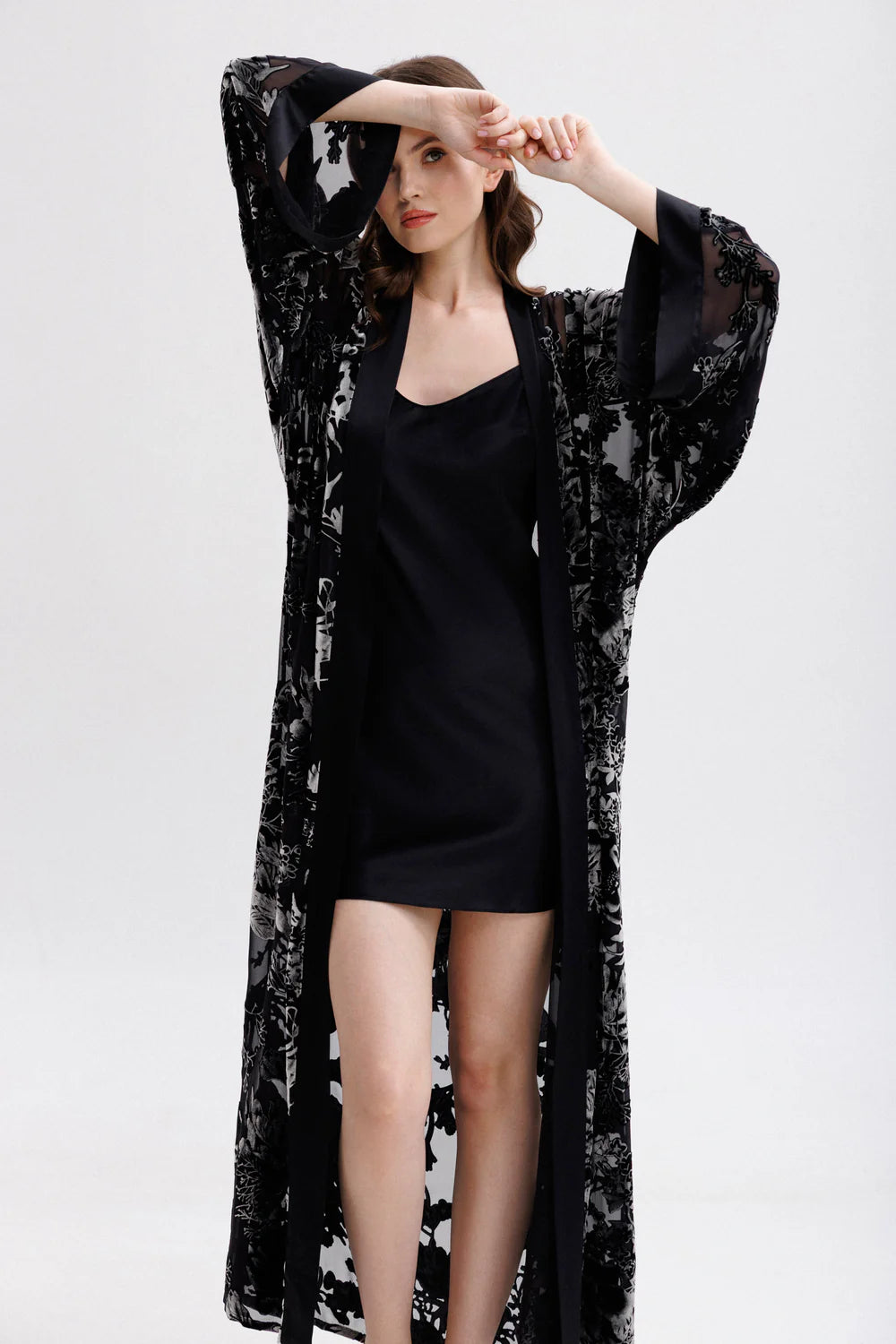 Woman wearing a black floral silk velvet kimono with matching nightgown (sold separately). Front picture