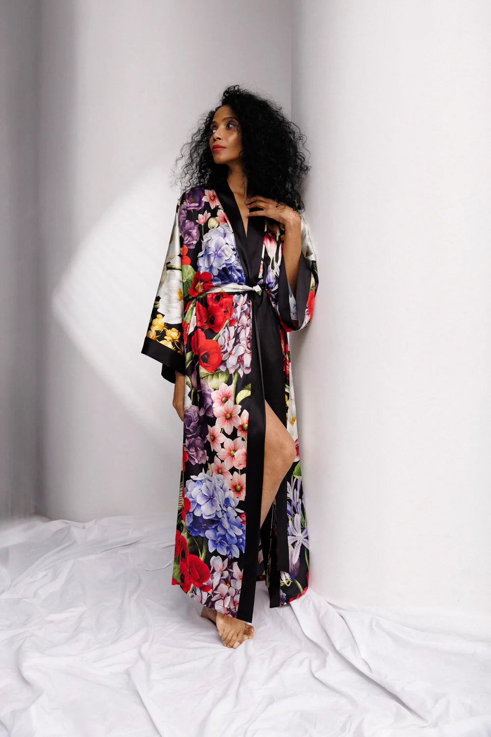 Woman wearing a colorful floral silk kimono , full front picture