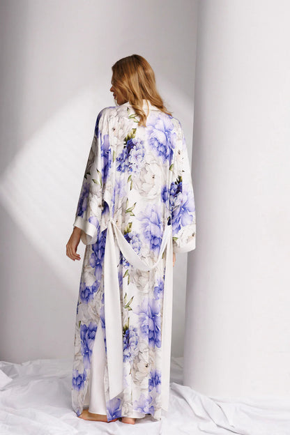Woman wearing a long floral silk robe with wide belt-back picture