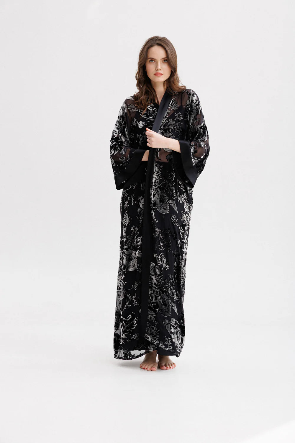 Woman wearing a black floral silk velvet kimono. Front picture