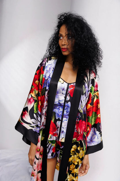Woman wearing a colorful floral silk kimono with a matching set of camisole and shorts (sold separately). Showing the front full picture.