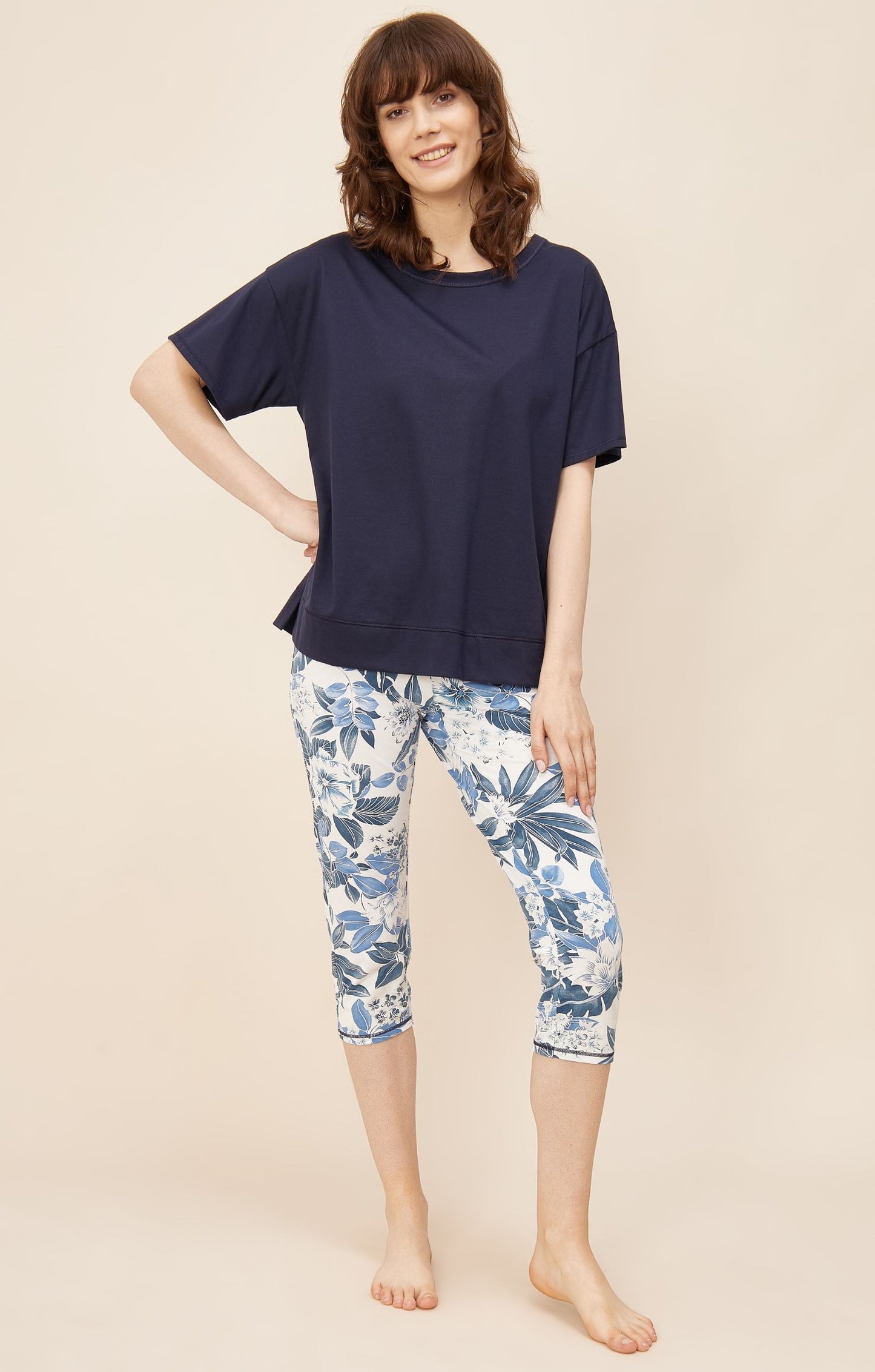 This two-piece pajama set from Rösch's Smart Casual collection is crafted from lightweight, supple single jersey cotton fabric, boasting a solid colored top and capri pants embellished with an indigo floral print.  Short sleeve  Wide crew-neck