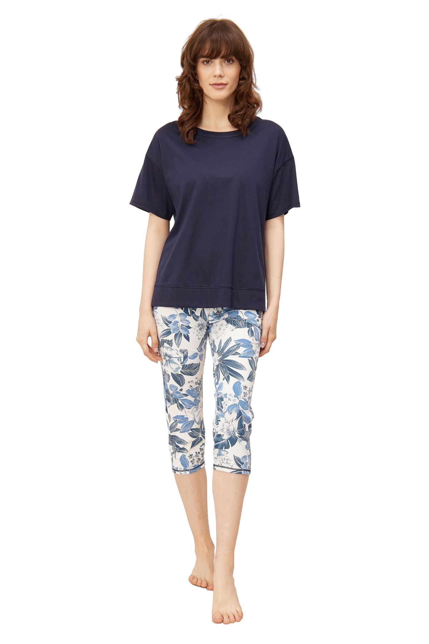This two-piece pajama set from Rösch's Smart Casual collection is crafted from lightweight, supple single jersey cotton fabric, boasting a solid colored top and capri pants embellished with an indigo floral print.  Short sleeve  Wide crew-neck